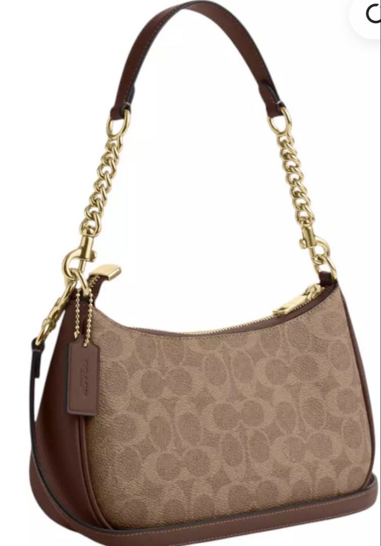 Coach Teri (Category: Cross-body Bags) located in San Mateo. Submitted by trendsph_956 (Listing ID 1467840995, Image 2). Description: - Brand: Coach - Material: Signature monogram canvas with brown leather trim - Hardware: Gold-tone details - Closure: Top zip closure with iconic leather hangtag - Strap: Short chain strap with a comfortable leather handle section - Structure: Structured base for an everyday classic look.