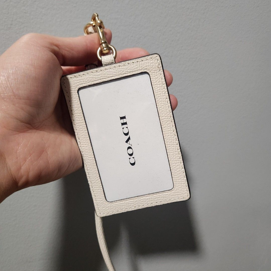 Coach White Leather ID Lanyard Card Holder (Category: Luxury Bags & Wallets) located in Pasay City. Submitted by dqueen28 (Listing ID 1468005133, Image 1). Description: - Brand: Coach - Material: Premium chalk white pebbled leather - Hardware: Gold-tone with lobster clasp clip - Strap: Matching neck strap attached - Design: Clear window slot on the front - Use: Ideal for office passes, IDs, and cards - Condition: Brand new with tag.