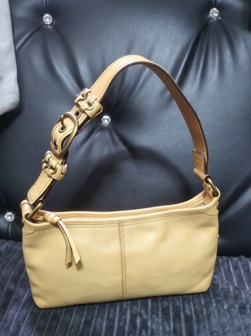 Coach Yellow Leather Shoulder Bag with Buckle Strap (Category: Luxury Bags & Wallets) located in Manila. Submitted by mozaitv1236506 (Listing ID 1467873507, Image 1). Description: - Authentic Coach leather shoulder bag in a gorgeous mustard yellow - Antique brass hardware and stylish contrast stitching detail - Secure top zipper closure with clean interior - Practical size for daily essentials - Minor signs of previous use on leather and hardware