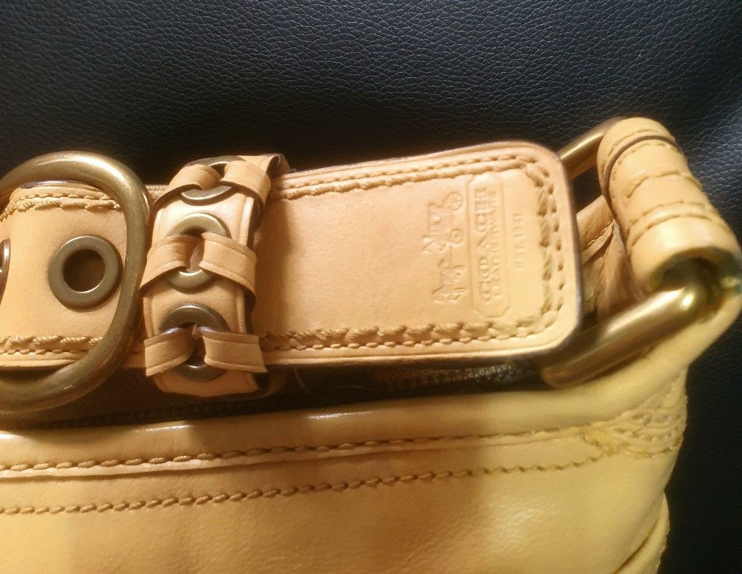 Coach Yellow Leather Shoulder Bag with Buckle Strap (Category: Luxury Bags & Wallets) located in Manila. Submitted by mozaitv1236506 (Listing ID 1467873507, Image 3). Description: - Authentic Coach leather shoulder bag in a gorgeous mustard yellow - Antique brass hardware and stylish contrast stitching detail - Secure top zipper closure with clean interior - Practical size for daily essentials - Minor signs of previous use on leather and hardware