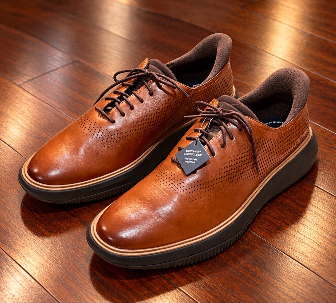 Cole Haan Grand Phase Laser Quick On Oxfords in British Tan-Java (Category: Casual Shoes) located in Paranaque City. Submitted by sole2squeeze (Listing ID 1467899527, Image 1). Description: - Brand: Cole Haan - Color: British Tan-Java - Material: Premium leather with perforated upper - Feature: Quick-on technology for hands-free slip-on functionality - Comfort: Cushioned interior collar and branded insoles - Sole: Dark chunky sole with grip patte