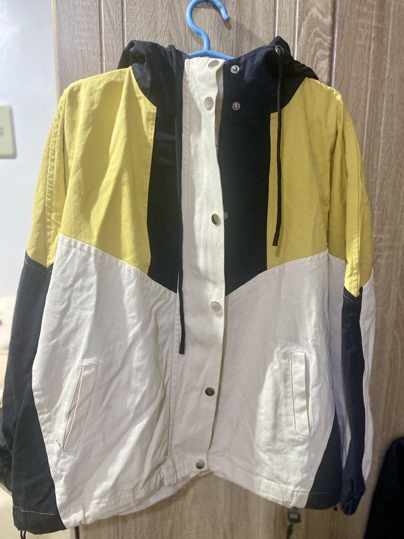 Colorblock Hooded Jacket Yellow White Black (Category: Coats, Jackets and Outerwear) located in Baras. Submitted by vale831 (Listing ID 1468031162, Image 1). Description: - Style: Casual streetwear colorblock hooded jacket - Colors: Yellow, white, and black panels - Features: Front snap button closure, adjustable hood drawstrings, and two front welt pockets - Condition: Clean, well-kept, and ready to wear - Best for: Great layering piece for cool
