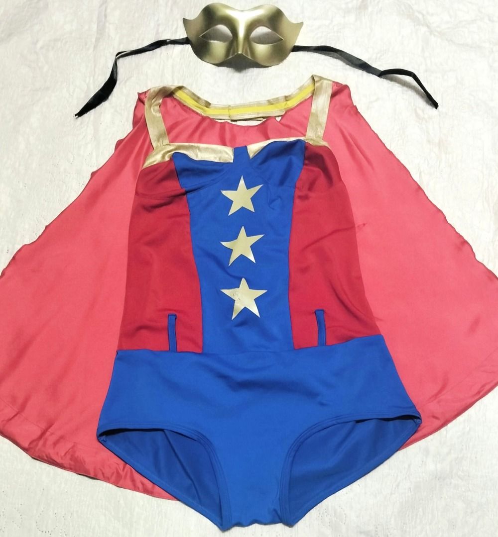 Comic Book Superhero Costume set with Cape and Mask (Category: Rompers) located in Taguig. Submitted by Bloomscorner1 (Listing ID 1468000005, Image 3). Description: - Set includes: Superhero bodysuit featuring a blue bottom, red-and-blue star-patterned torso, a matching shiny red cape with gold border and comic book 'BOOM' graphic on the back - Also includes accessories: Gold mask with black tie strings. - Pls. note, the headband is replaced by t