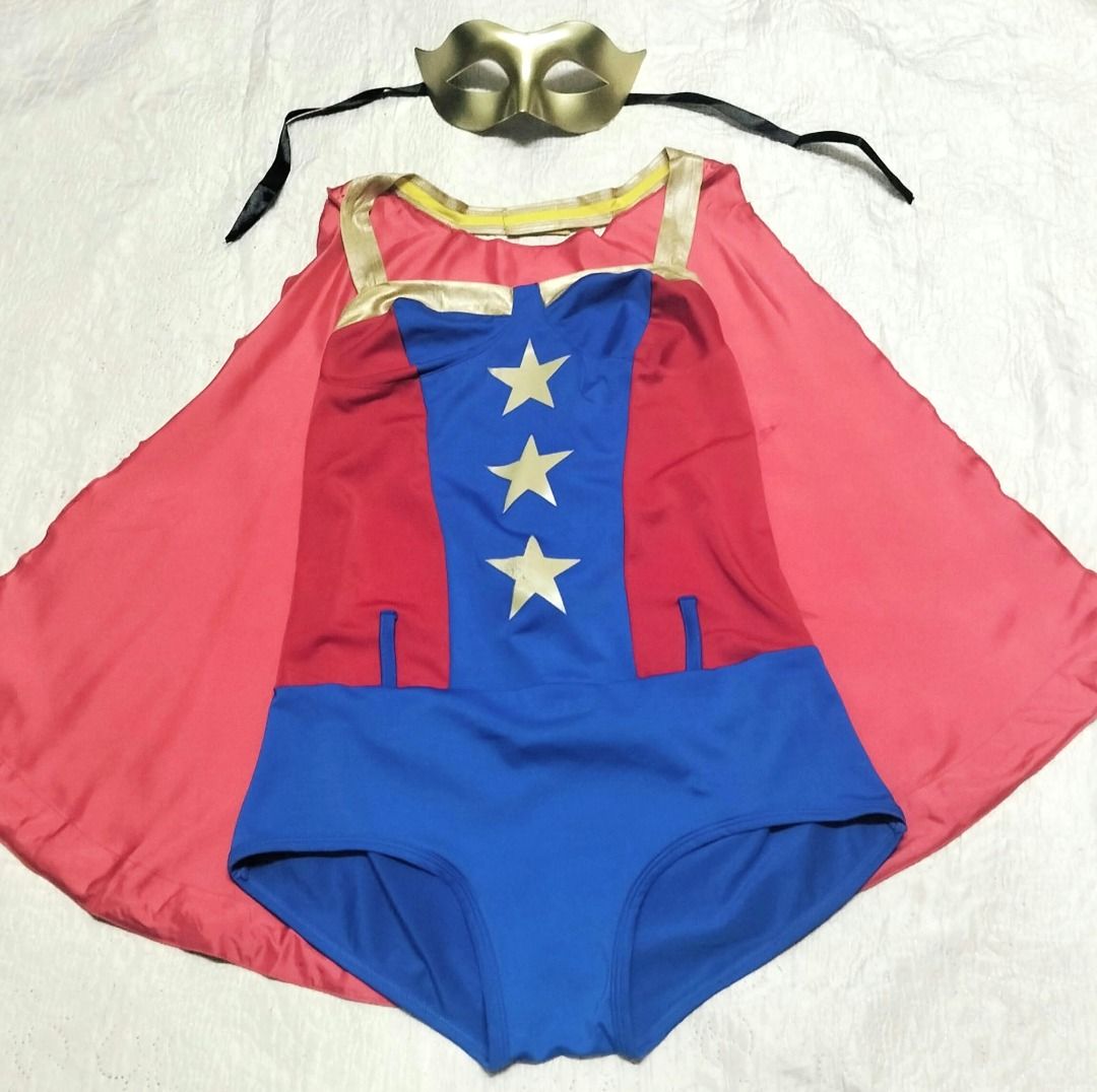 Comic Book Superhero Costume set with Cape and Mask (Category: Rompers) located in Taguig. Submitted by Bloomscorner1 (Listing ID 1468000005, Image 2). Description: - Set includes: Superhero bodysuit featuring a blue bottom, red-and-blue star-patterned torso, a matching shiny red cape with gold border and comic book 'BOOM' graphic on the back - Also includes accessories: Gold mask with black tie strings. - Pls. note, the headband is replaced by t