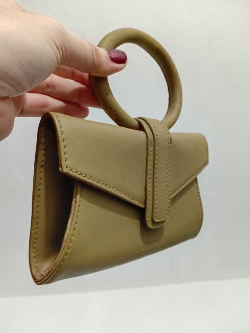 Complét Mini Satchel Bag (Category: Luxury Bags & Wallets) located in Manila. Submitted by eriiicaspage (Listing ID 1467883649, Image 2). Description: PreOwned WellUsed Authentic Complét Mini Satchel bag Clutch ,Mini handbag ,(Project bag ) -XXS ,Micro ,Compact sized - Color: Sophisticated olive green - Material: Premium leather - Design: Structured mini bag with a eye-catching round ring top handle - Closure: Flap front with secure magnetic snap