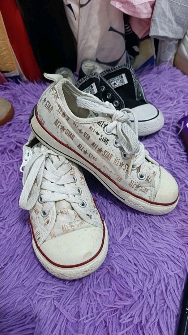 Converse All Star kids sneakers bundle black and white (Category: Babies & Kids Fashion) located in Manila. Submitted by cleverearth.ed94b6 (Listing ID 1468000577, Image 2). Description: TAKE ALL - Set of 2 pairs of classic low-top Converse All Star kids sneakers - Pair 1: converse black 13cm - Pair 2: Off-white canvas with repeating All Star text print and standard laces 15cm - Condition: Visible wear on rubber toes and soles from normal use.