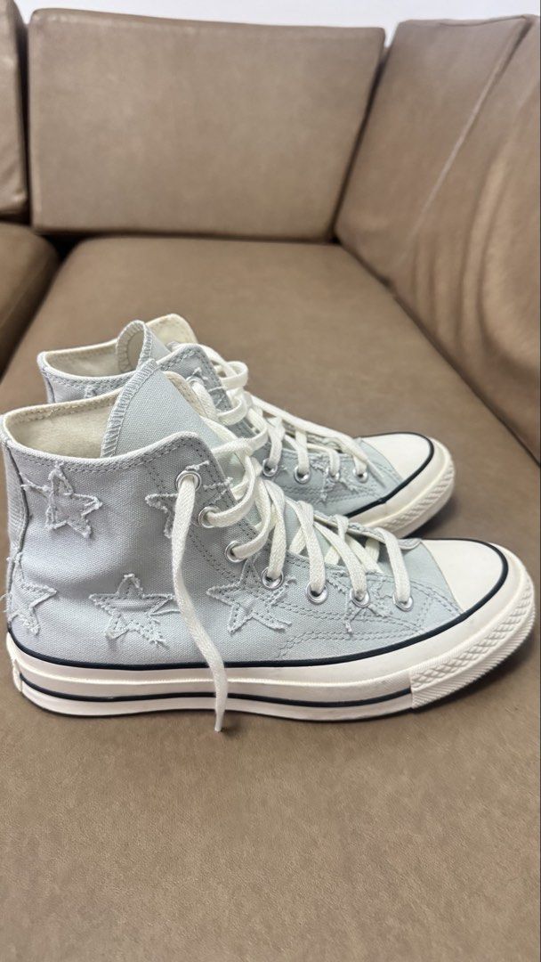 Converse Chuck 70 High Top Star Distressed Grey (Category: Sneakers) located in Agdangan. Submitted by chiechie.567 (Listing ID 1467997084, Image 3). Description: - Model: Converse Chuck 70 High Top - Color: Light blue - Material: Distressed canvas upper with frayed star appliques - Details: Classic white rubber toe cap, midsole with black piping, and white laces - Condition: Clean interior and crisp white soles - Style: Unique textured design, v