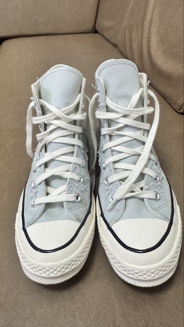 Converse Chuck 70 High Top Star Distressed Grey (Category: Sneakers) located in Agdangan. Submitted by chiechie.567 (Listing ID 1467997084, Image 2). Description: - Model: Converse Chuck 70 High Top - Color: Light blue - Material: Distressed canvas upper with frayed star appliques - Details: Classic white rubber toe cap, midsole with black piping, and white laces - Condition: Clean interior and crisp white soles - Style: Unique textured design, v