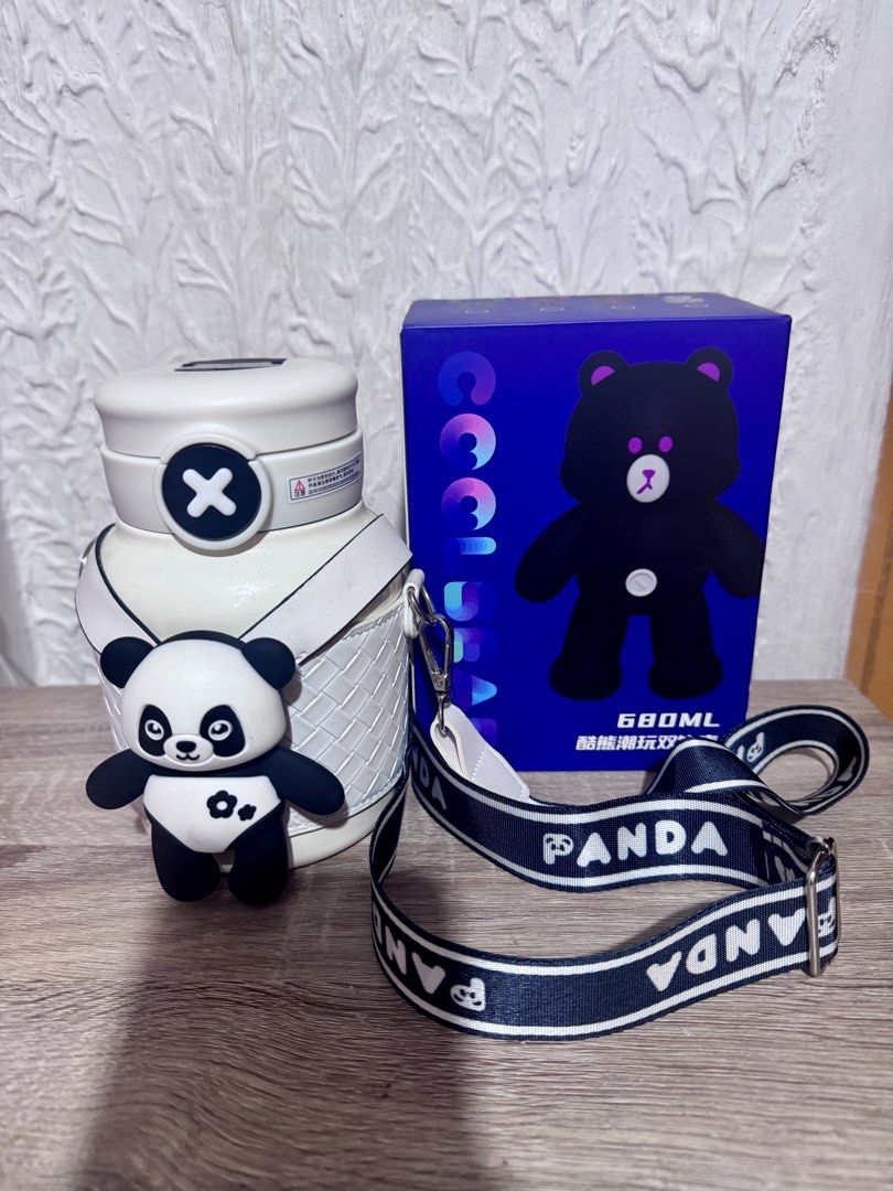 Cool Bear 680ml Panda Water Bottle with Strap (Category: Water Bottles & Tumblers) located in Dasmarinas. Submitted by gladz.ck (Listing ID 1468029469, Image 1). Description: - Capacity: 680ml - Color: White body with secure cap design - Strap: Detachable black and white strap with 'PANDA' wording - Accessory: Matching 3D panda figurine attached to the carrier - Packaging: Original blue box included.