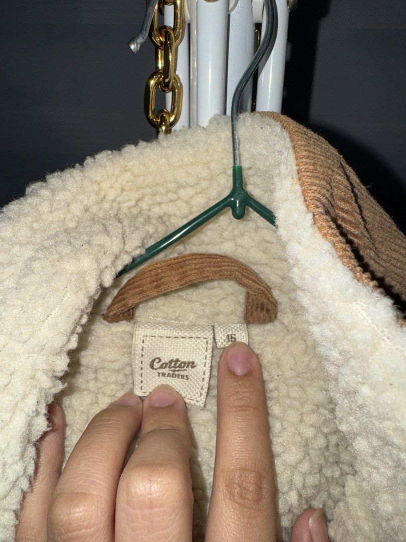 Cotton Traders Sherpa Lined Corduroy Jacket Size 16 (Category: Coats, Jackets and Outerwear) located in La Trinidad. Submitted by prelovedandfindsbyji (Listing ID 1467929826, Image 2). Description: - Brand: Cotton Traders - Color: Olive green with cream sherpa lining - Material: 100% cotton outer, 100% polyester lining - Size: 16 (tag attached near collar) - Features: Button-up front with matching buttons, two chest pockets with button flaps - Fi