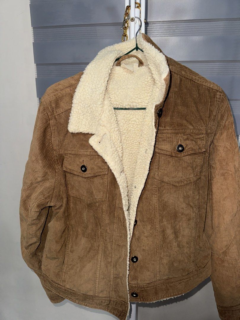 Cotton Traders Sherpa Lined Corduroy Jacket Size 16 (Category: Coats, Jackets and Outerwear) located in La Trinidad. Submitted by prelovedandfindsbyji (Listing ID 1467929826, Image 3). Description: - Brand: Cotton Traders - Color: Olive green with cream sherpa lining - Material: 100% cotton outer, 100% polyester lining - Size: 16 (tag attached near collar) - Features: Button-up front with matching buttons, two chest pockets with button flaps - Fi