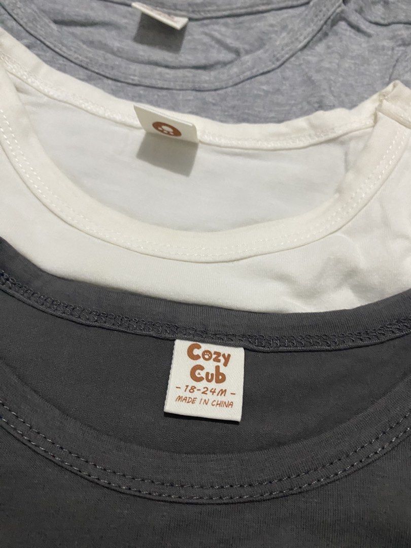 Cozy Cub Toddler T-Shirts Bundle 18-24M (Category: Babies & Kids Fashion) located in Manila. Submitted by love_mami (Listing ID 1467912003, Image 2). Description: - Brand: Cozy Cub - Size: 18-24 months - Quantity: Bundle of 4 t-shirts - Colors: Black, grey, white, and dark grey - Design: Short sleeves, round neckline, plain solid colors - Material: Soft, breathable cotton - Condition: Great for everyday wear and easy to mix and match with any bot