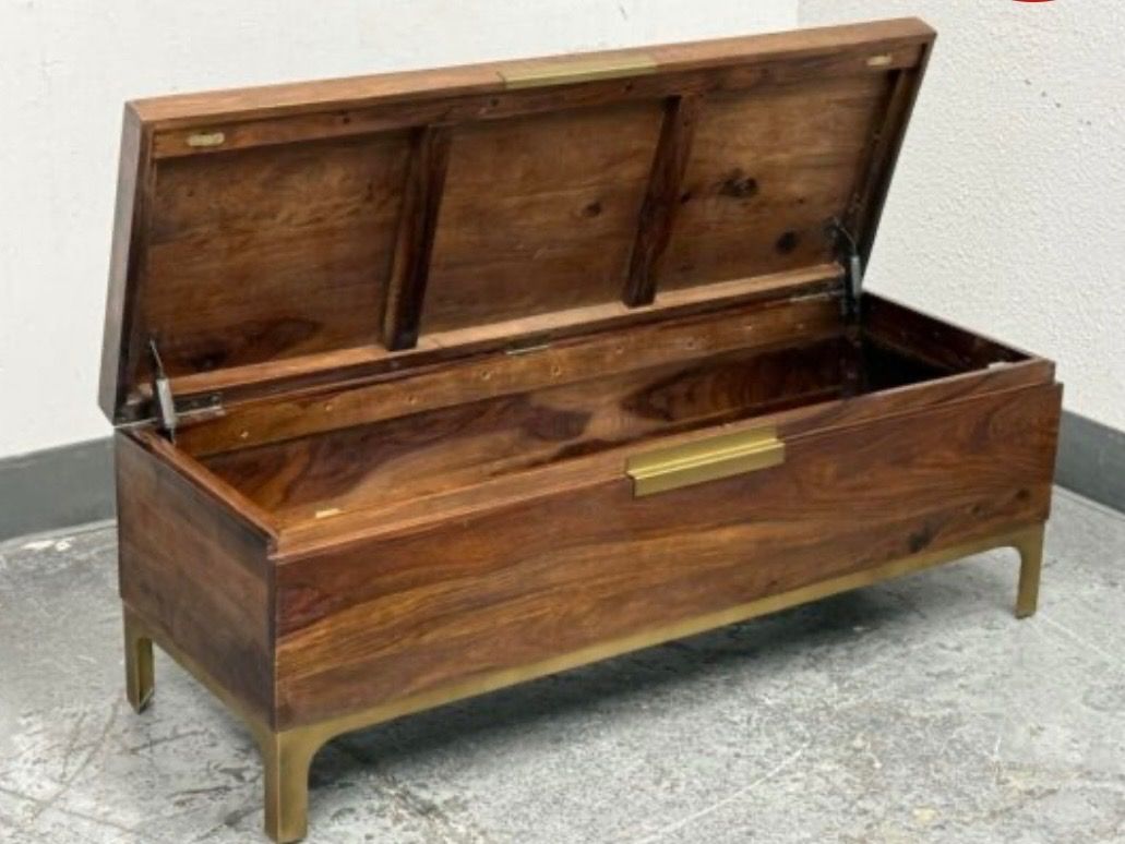 Crate & Barrel Jada Trunk (Category: Other Home Furniture) located in Caloocan City. Submitted by crateandbarrel (Listing ID 1468028629, Image 2). Description: Accents: Designed with slender, burnished bronze-toned metal legs and a matching discreet center pull on the flip-top lid. Dimensions: Approximately 129.5 cm wide, 45.7 cm deep, and 45.1 cm high. - Style: Mid-century modern aesthetic with clean lines - Material: Rich wood with natural grai