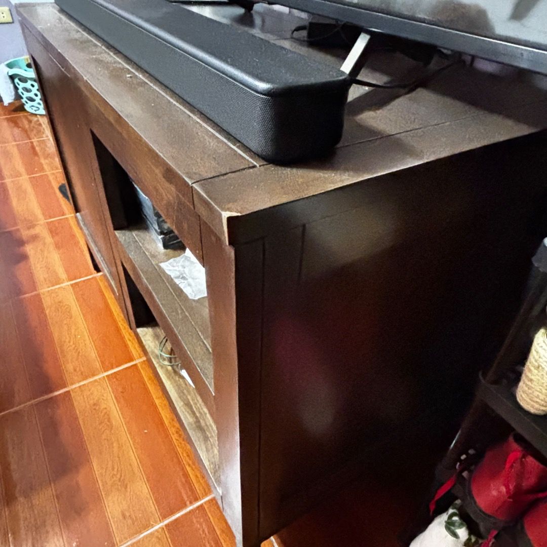 Crate & Barrel Wyatt 40" Media Console (Category: TV Consoles) located in Caloocan City. Submitted by crateandbarrel (Listing ID 1468029870, Image 3). Description: Overall Dimensions Width: 101.6cm Height: 71.12cm Depth: 50.8cm Height: 12.7cm This piece is crafted from solid wood and is recognizable by its flush inset cabinet doors, minimalist open storage shelves, and slim black iron frame base legs. - Rich brown wood grain finish with sturdy bl