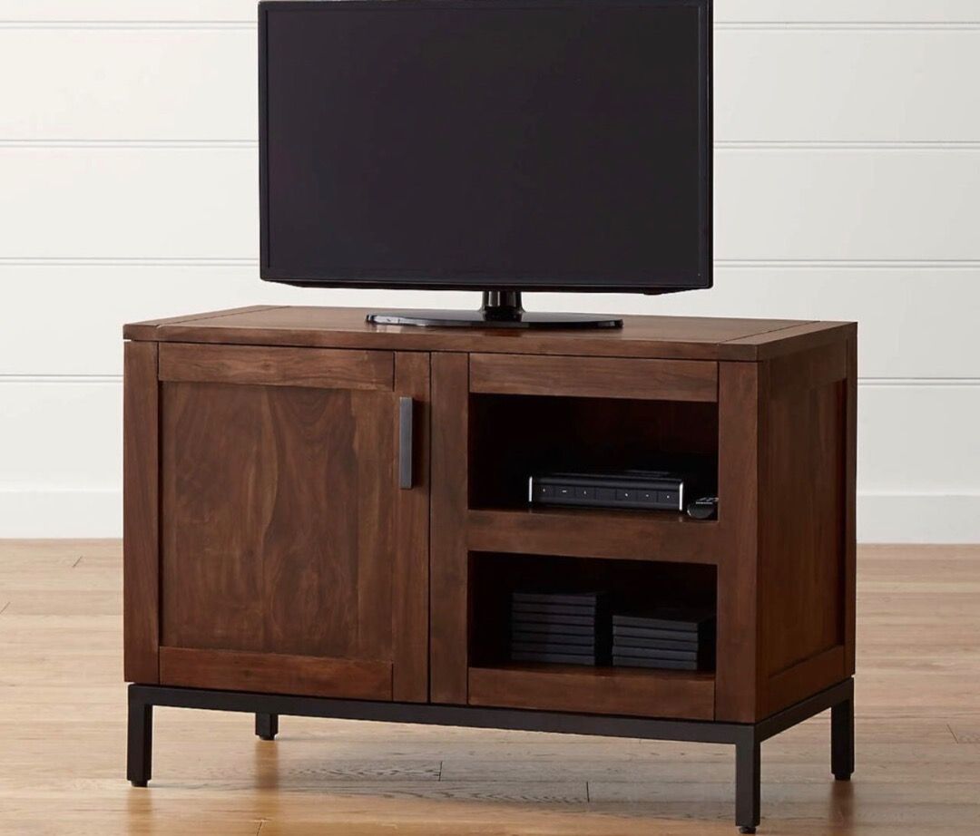 Crate & Barrel Wyatt 40" Media Console (Category: TV Consoles) located in Caloocan City. Submitted by crateandbarrel (Listing ID 1468029870, Image 2). Description: Overall Dimensions Width: 101.6cm Height: 71.12cm Depth: 50.8cm Height: 12.7cm This piece is crafted from solid wood and is recognizable by its flush inset cabinet doors, minimalist open storage shelves, and slim black iron frame base legs. - Rich brown wood grain finish with sturdy bl