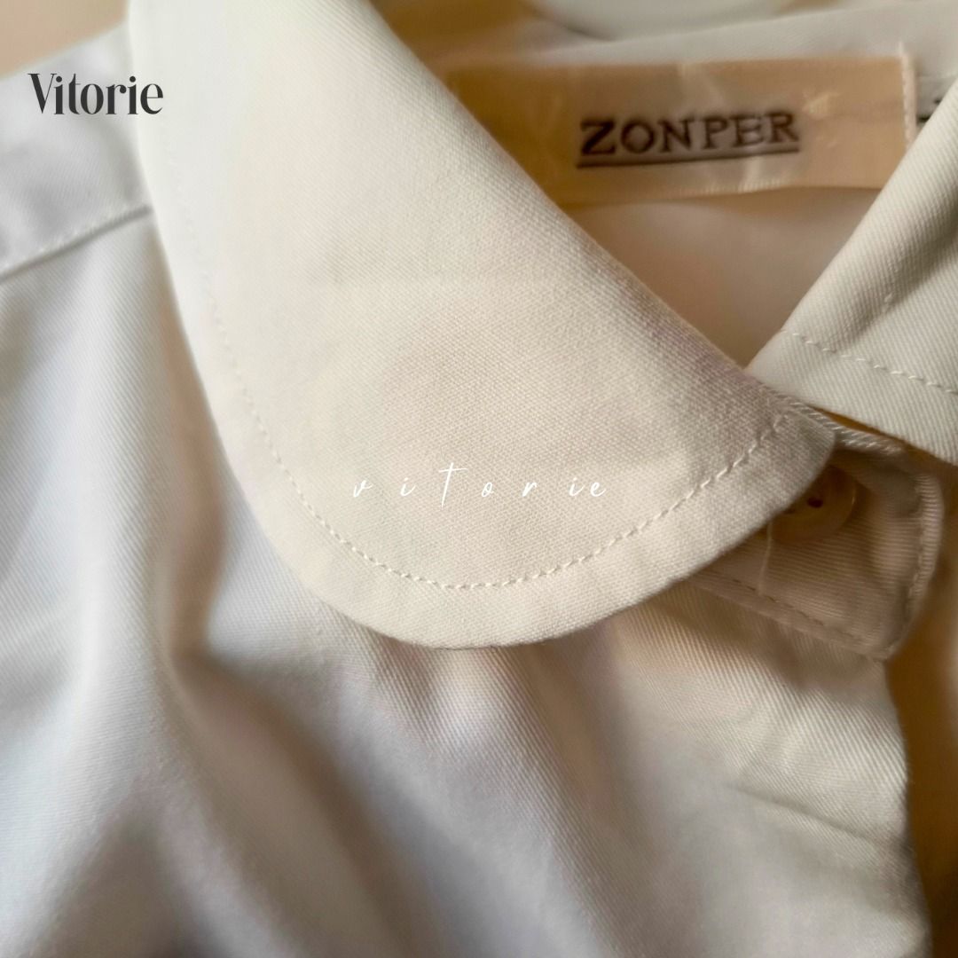 Cream Short Sleeve Peter Pan Collar Button Down Blouse (Category: Blouses) located in Cabuyao City. Submitted by vitorieclothing_lifestyle (Listing ID 1467886915, Image 2). Description: - Style: Cream short sleeve button-down shirt with a sweet Peter Pan collar and one chest pocket - Fabric: Lightweight, breathable, and very easy to style for work or casual outings - Size: Medium - Measurements: Shoulder 16", Bust 40", Length 26", Sleeves 8", Arm