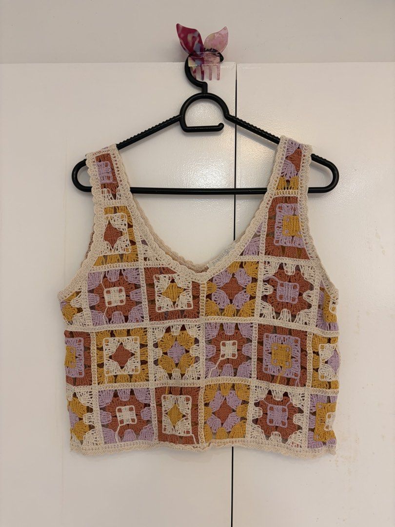 Crochet Granny Square Tank Top (Category: Sleeveless) located in Quezon City. Submitted by prelovedbynxkole (Listing ID 1467884874, Image 1). Description: - Brand: REBELLION - Style: Crochet tank top with colorful granny square pattern - Colors: Cream base with mustard yellow, dusty rose, and lavender patches - Details: V-neckline, sleeveless - Size: M - Condition: Worn once - Perfect for: Casual days out, looks super cute with high-waisted jeans