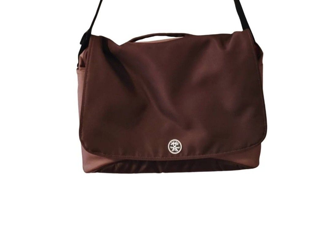 Crumpler Messenger Bag Brown Shoulder Bag (Category: Sling Bags) located in Cebu City. Submitted by krisiiiiesale (Listing ID 1468001253, Image 3). Description: - Brand: Crumpler - Color: Deep Brown - Condition: Excellent, minimal wear on hardware and fabric, clean inside and out - Features: Adjustable black strap, convenient top handle grip, iconic Crumpler logo snap button closure - Capacity: Roomy interior ideal for daily commute, school, or c