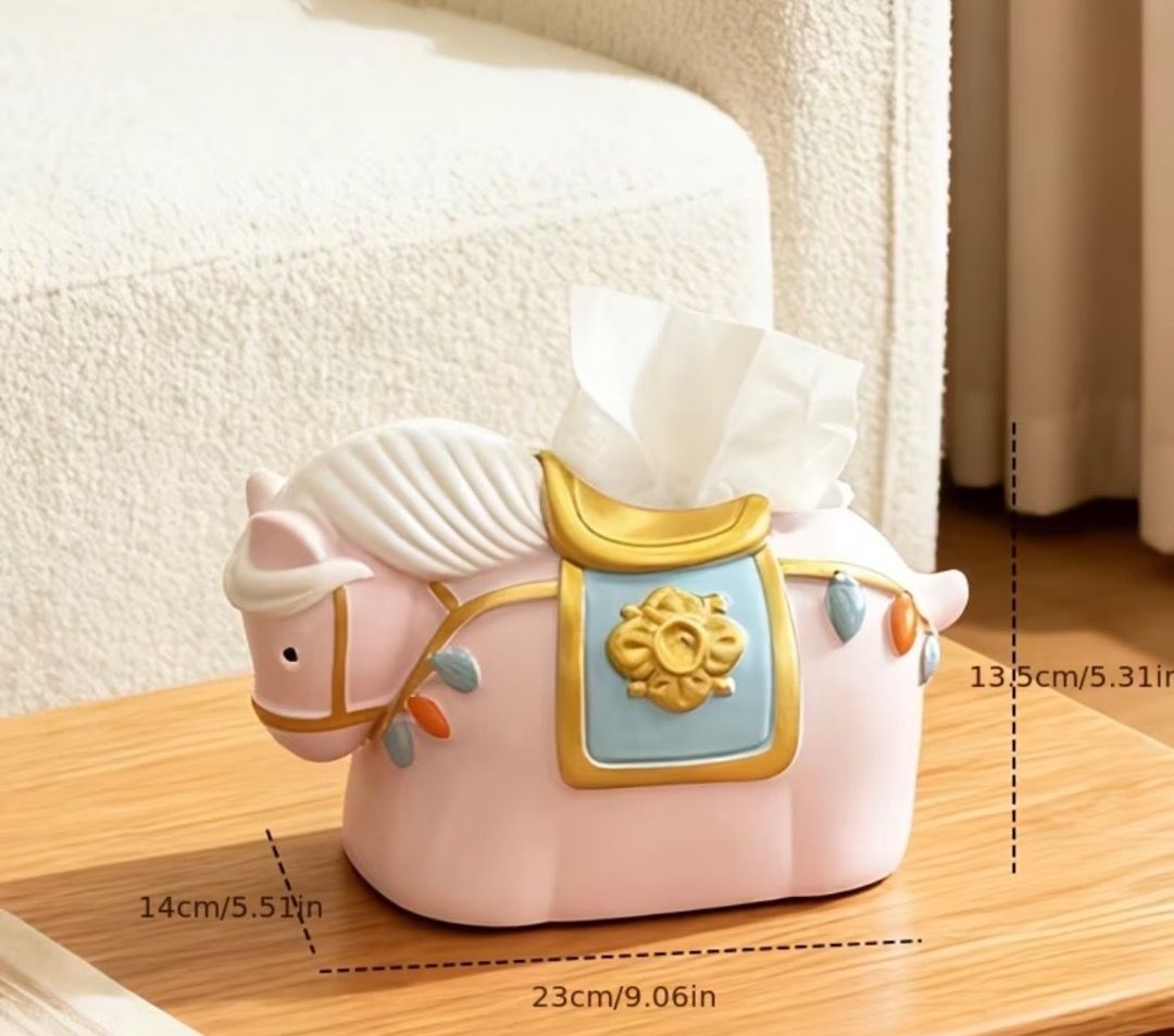 Cute Pink Horse Tissue Box Holder Table Decor (Category: Designer & Blind Box Toys) located in Subic. Submitted by anything_lovely_under_the_sun (Listing ID 1467917283, Image 2). Description: - Adorable pink horse design with stylish gold and blue saddle accents - Fits standard facial tissues easily - Dimensions: 23cm (L) x 14cm (W) x 13.5cm (H) - Adds a fun and playful touch to living room or bedroom tables - Great conversation piece and home de