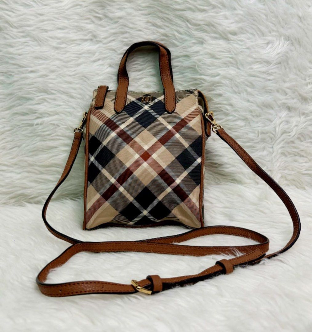 Daks Mini Tote Bag with Crossbody Strap (Category: Tote Bags) located in Bacolod City. Submitted by denden_andmore (Listing ID 1467863185, Image 1). Description: - Classic plaid pattern with brown leather-look trim - Secure top zipper closure for daily essentials - Includes top handles and an adjustable crossbody strap - Elegant gold-tone hardware accents - Compact, structured, and easy to style.