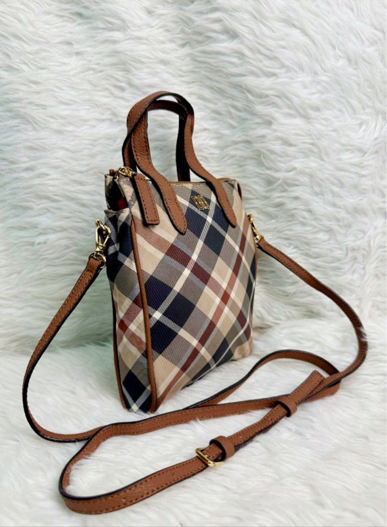 Daks Mini Tote Bag with Crossbody Strap (Category: Tote Bags) located in Bacolod City. Submitted by denden_andmore (Listing ID 1467863185, Image 2). Description: - Classic plaid pattern with brown leather-look trim - Secure top zipper closure for daily essentials - Includes top handles and an adjustable crossbody strap - Elegant gold-tone hardware accents - Compact, structured, and easy to style.