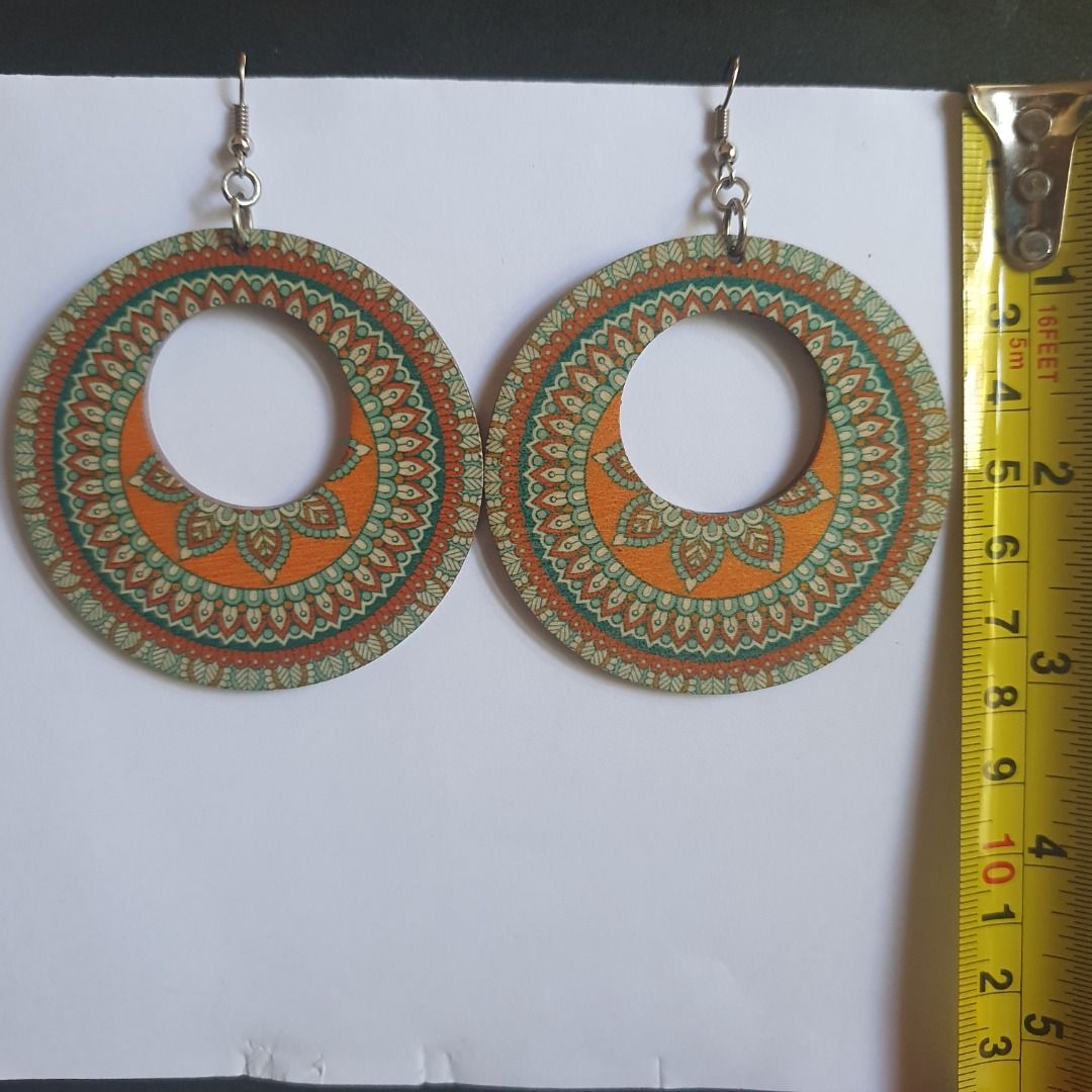 Dangling wooden statement earrings (Category: Earrings) located in Caloocan City. Submitted by mma_222 (Listing ID 1467904502, Image 1). Description: - Set of 5 assorted wooden drop earrings - Includes colorful mandalas, butterfly cutouts, medallions, and patterned dangles - Lightweight wood material with secure metal hooks - Versatile bohemian style for everyday use or special occasions - Great variety pack offering different shapes and patterns