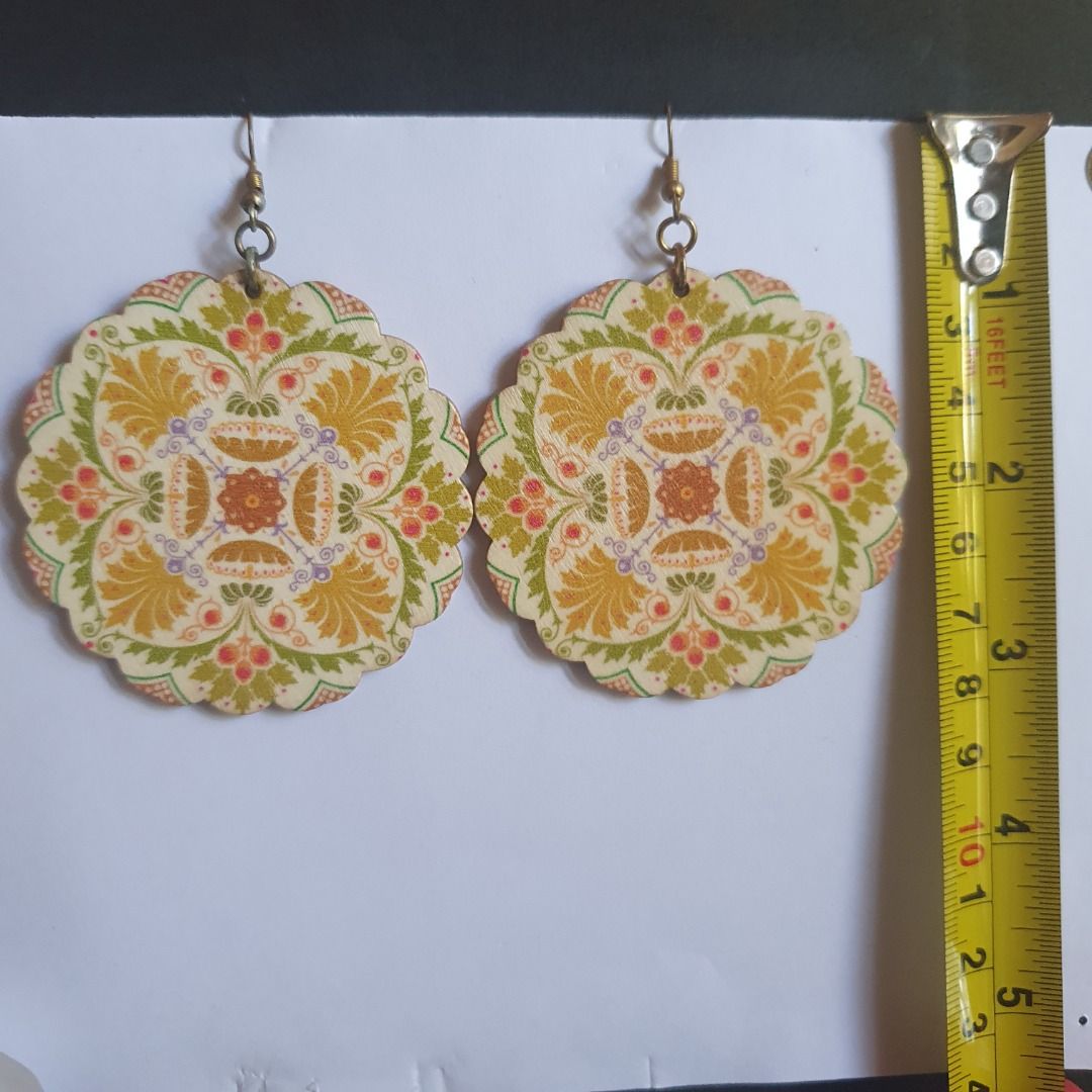 Dangling wooden statement earrings (Category: Earrings) located in Caloocan City. Submitted by mma_222 (Listing ID 1467904502, Image 3). Description: - Set of 5 assorted wooden drop earrings - Includes colorful mandalas, butterfly cutouts, medallions, and patterned dangles - Lightweight wood material with secure metal hooks - Versatile bohemian style for everyday use or special occasions - Great variety pack offering different shapes and patterns