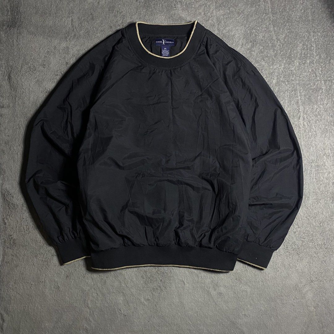 Daniel Cremieux Black Windbreaker Pullover Sweatshirt Size XXL (Category: Coats, Jackets and Outerwear) located in Manila. Submitted by thrifturfit_star (Listing ID 1467846070, Image 1). Description: - Brand/Model: Daniel Cremieux Pullover Jacket - Color: Classic black with light tan tipping details on cuffs, hem, and crewneck - Size: XXL - Material: Lightweight windbreaker style - Design: Clean look with subtle embroidered golf silhouette logo o