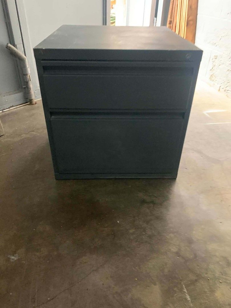 Dark Grey Metal 2-Drawer Filing Cabinet (Category: Office Furniture & Fixtures) located in Manila. Submitted by cleverocean.10acf9 (Listing ID 1467918246, Image 1). Description: - Color/Material: Dark grey solid metal - Storage: 2 spacious drawers for documents - Design: Sturdy, heavy-duty industrial look - Dimensions: Standard desk height - Ideal for: Home office or workspace storage - Condition: Clean surface, ready for pickup.