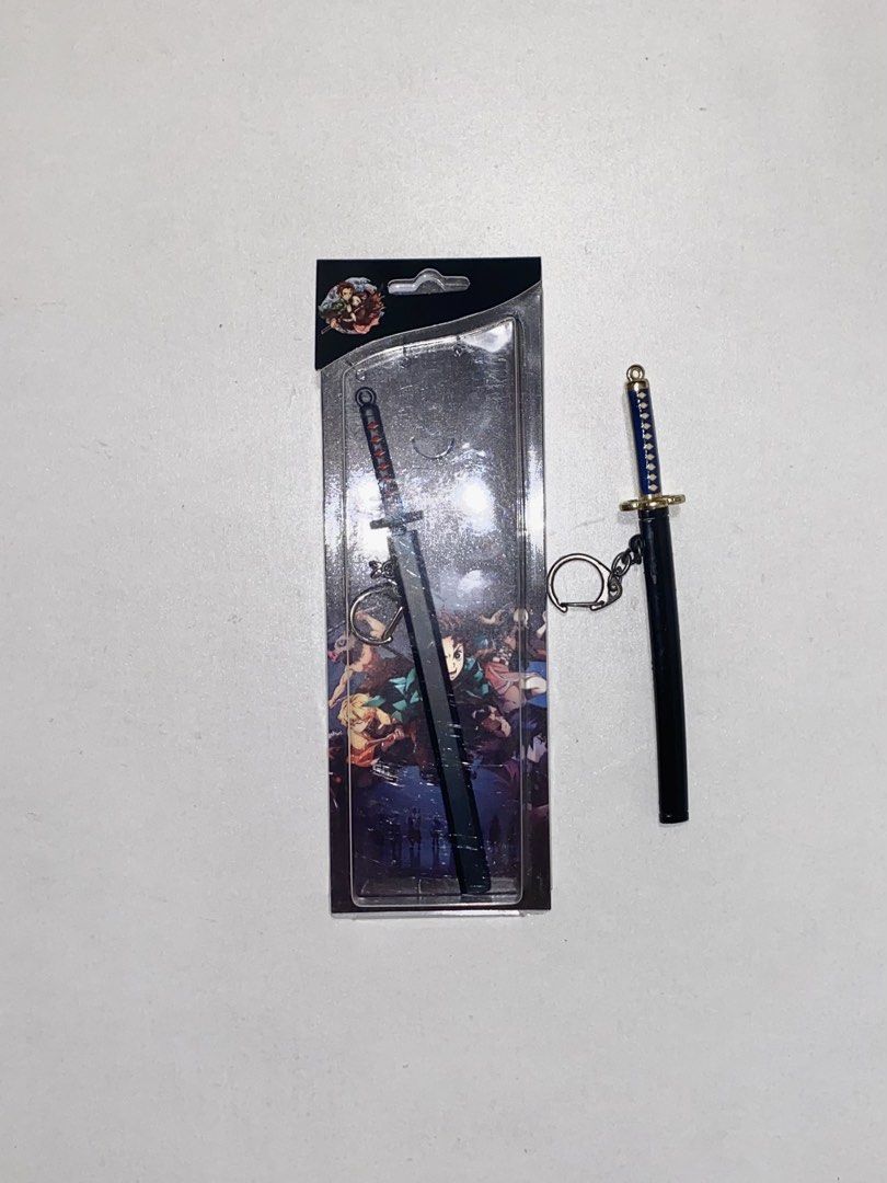 Demon Slayer Sword Keychain + FREE Sword Keychain (Category: Character Goods) located in Cainta. Submitted by papillon_309909 (Listing ID 1468000844, Image 1). Description: Free keychain (used).