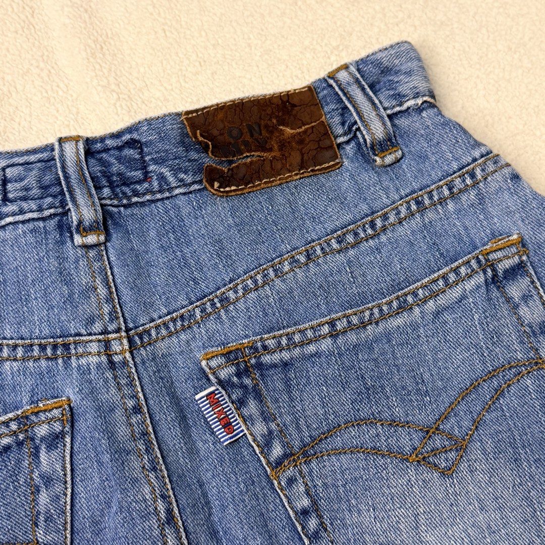 Vintage Denim Midi Skirt - Blue Front Split (Category: Skirts) located in Agdangan. Submitted by thriftiesbyash (Listing ID 1467928420, Image 3). Description: - Style: High-waisted midi denim skirt with a trendy front split and flare hem - Wash: Classic medium blue - Details: Five-pocket design, belt loops, leather back patch, and branded logo tab - Closure: Front button and zip fly - Condition: Excellent mixed brand piece, perfect for casual eve