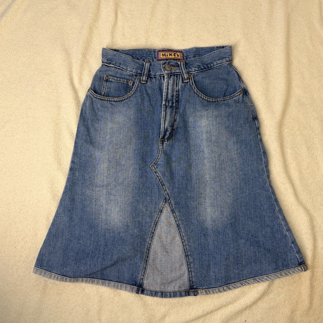 Vintage Denim Midi Skirt - Blue Front Split (Category: Skirts) located in Agdangan. Submitted by thriftiesbyash (Listing ID 1467928420, Image 1). Description: - Style: High-waisted midi denim skirt with a trendy front split and flare hem - Wash: Classic medium blue - Details: Five-pocket design, belt loops, leather back patch, and branded logo tab - Closure: Front button and zip fly - Condition: Excellent mixed brand piece, perfect for casual eve