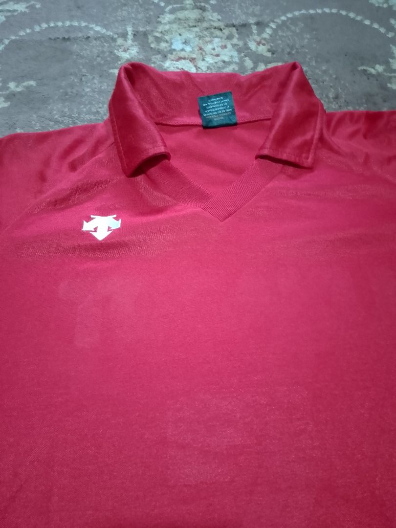 Descente Functional Sports System Red Polo Jersey (Category: Tshirts & Polo Shirts ) located in Bayombong. Submitted by daily10 (Listing ID 1467888251, Image 3). Description: - Brand: Descente (Functional Sports System) - Est Size: L - Dimensions: 21" x 27" - Shadow print at back - Color: Bright red with white chest logo - Style: V-neck polo, short sleeves - Material: Breathable athletic mesh-like fabric - Ideal for: Workouts, sports, or casual w