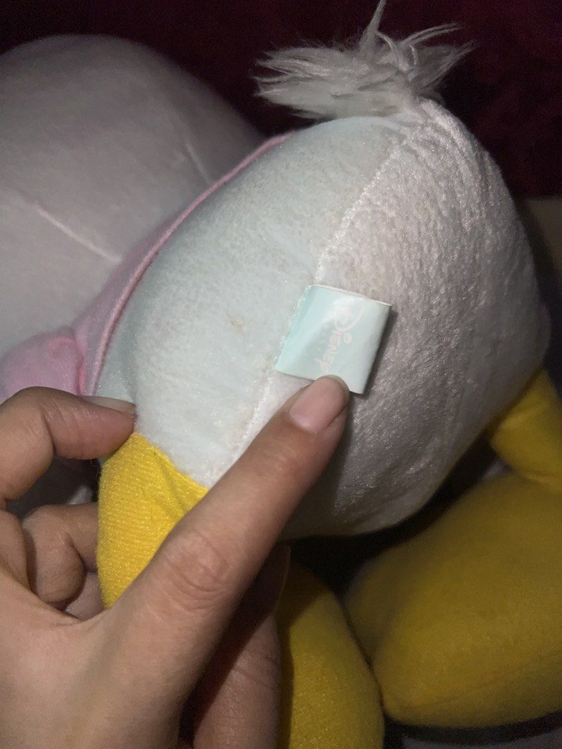 Disney Daisy Duck Plush Toy Doll (Category: Plushies & Soft Toys) located in Bulacan. Submitted by haven_plushie_dolls.888 (Listing ID 1467958508, Image 3). Description: - Crafted from ultra-soft fabric, perfect for cuddling or display - Adorable design featuring a pink bow, pink shirt, and playful winking eye - Features official 'Daisy' embroidery on the yellow foot - Great gift idea for kids, fans, and Disney merchandise collectors -Need wash.