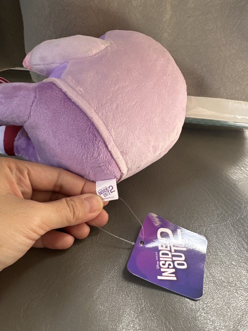 Disney Pixar Inside Out 2 Envy Plush (Category: Plushies & Soft Toys) located in Cainta. Submitted by shopbyyna (Listing ID 1467872293, Image 2). Description: - Official Disney Pixar Inside Out 2 Envy plush toy - Outfit: Purple hoodie, matching pants, and white sneakers - Condition: Brand new with original tag still attached - Fabric is clean and filling is super soft - Perfect for collectors and fans of all ages.