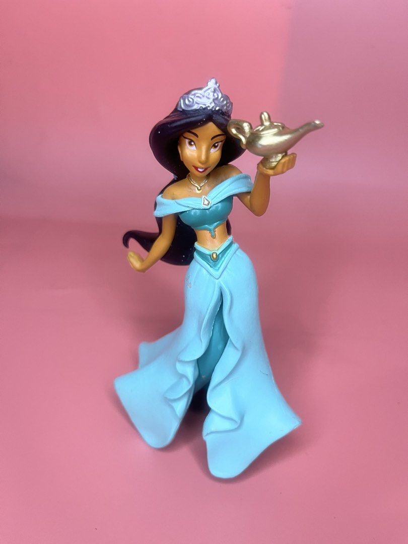 Disney Princess Jasmine Figurine with Magic Lamp (Category: Figurines & Statues) located in Caloocan City. Submitted by snapshop_ph (Listing ID 1468055424, Image 1). Description: - Character: Disney Princess Jasmine holding a gold-colored magic lamp - Appearance: Iconic teal outfit, matching skirt, and tiara in black hair - Authenticity: Official Disney copyright stamp on the underside of the base - Condition: Stands upright on a flat surface; mi
