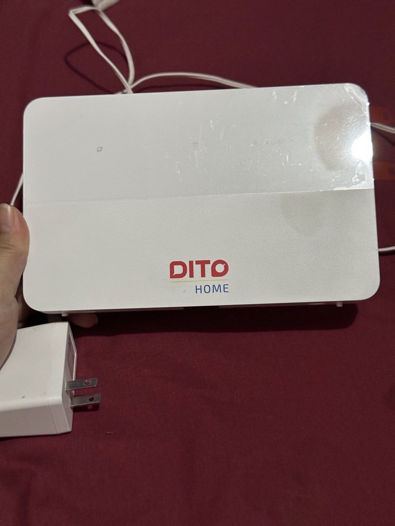 Dito Home Wireless Router Modem (Category: Networking) located in Quezon City. Submitted by happyforest-4e3d (Listing ID 1467853375, Image 1). Description: - Dito Home wireless router (white with red and blue branding) - Clean exterior, works great for home internet setup - Includes power adapter and attached cable - Back ports: Power slot, Reset button, LAN/WAN port, WPS button - No Sim.