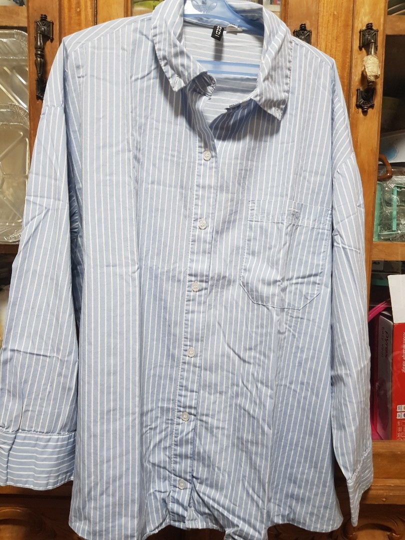 Divided by H&M Blue White Striped Button Down Shirt (Category: Shirts) located in Baguio. Submitted by soonshimcart (Listing ID 1467854714, Image 1). Description: - Brand: H&M - Style: Blue and white striped long-sleeve shirt with button-down front and classic collar - Size: Medium - Features: Single chest pocket, lightweight cotton blend - Condition: Excellent, clean with no stains or tears.