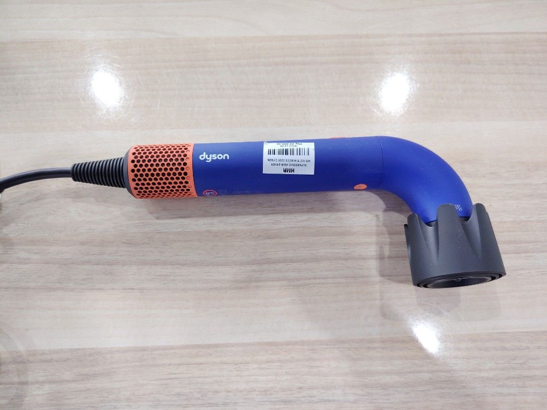 Dyson Supersonic Hair Dryer (Category: Hair) located in Manila. Submitted by riley1205 (Listing ID 1467861173, Image 3). Description: - Dyson Supersonic Hair Dryer - Authentic - Striking Blue and Orange colorway - Fully tested and 100% functional - Includes power cable with large plug brick - Comes with multiple attachment nozzles and diffuser - Complete with original cardboard box - Perfect condition and ready for your hair styling routine.