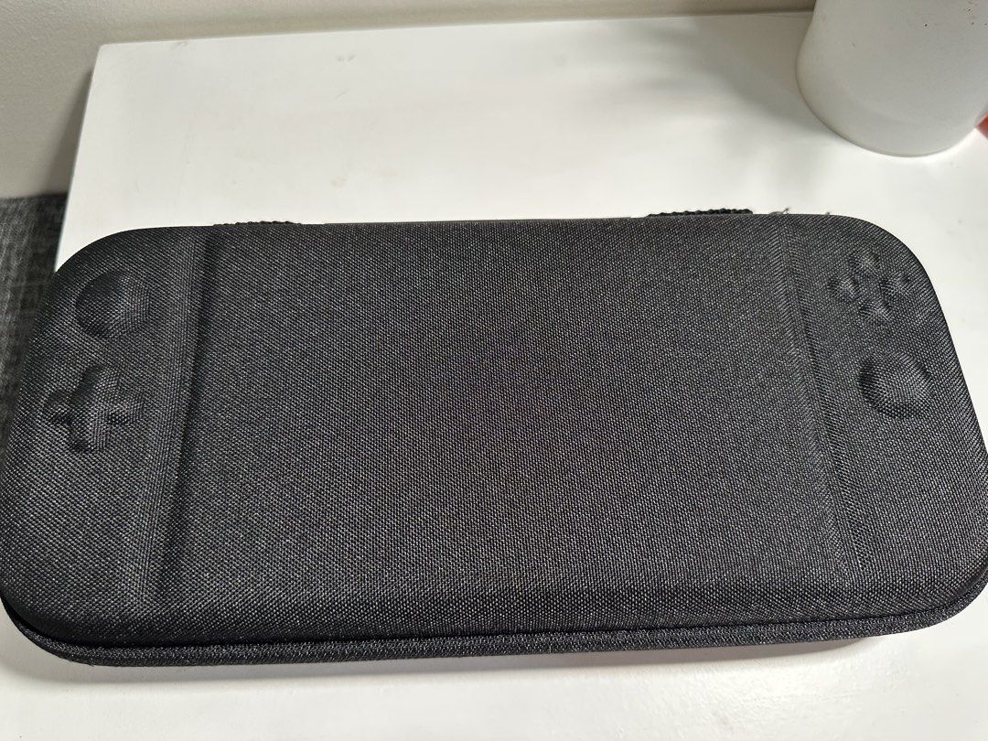 ECHTPower Carry Case for Nintendo Switch (Category: Cases & Covers) located in Cabanatuan. Submitted by s.kit.27 (Listing ID 1468026104, Image 2). Description: - Brand new, unused in original plastic packaging - Tough black hard shell exterior with custom joystick molds - Built-in zipped mesh pocket for accessories and cables - Dedicated game cartridge storage with soft velvet backing - Secure pull strap for effortless console removal.