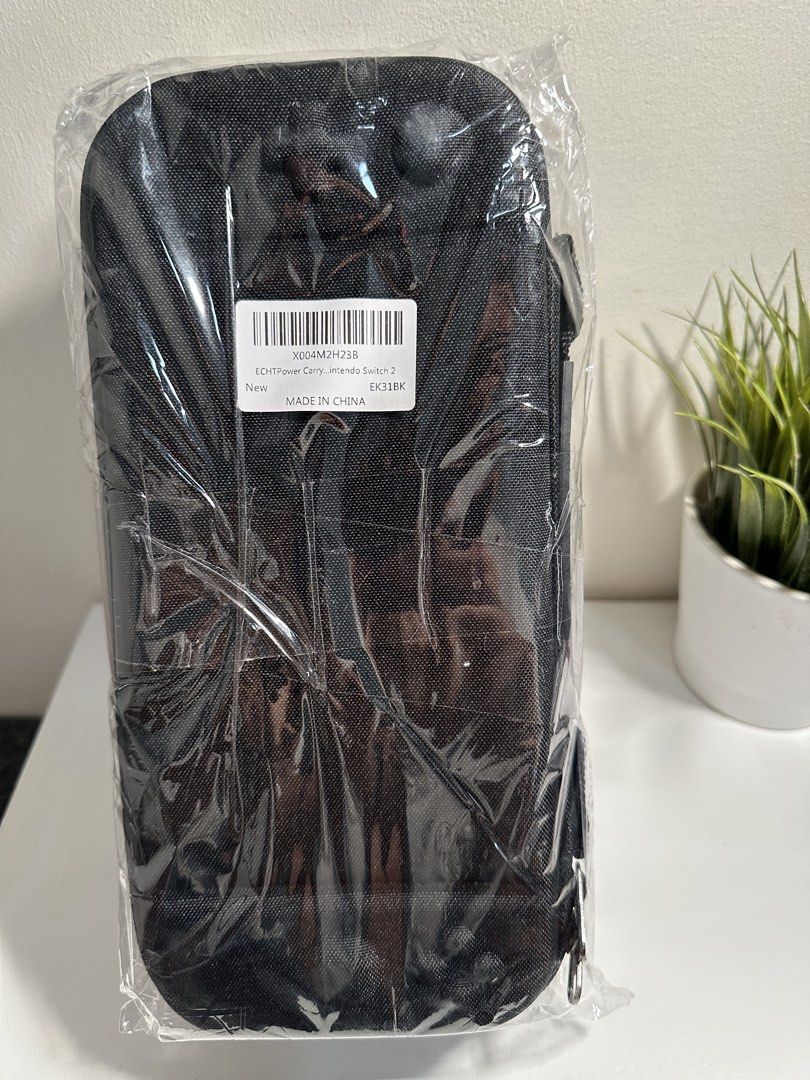ECHTPower Carry Case for Nintendo Switch (Category: Cases & Covers) located in Cabanatuan. Submitted by s.kit.27 (Listing ID 1468026104, Image 1). Description: - Brand new, unused in original plastic packaging - Tough black hard shell exterior with custom joystick molds - Built-in zipped mesh pocket for accessories and cables - Dedicated game cartridge storage with soft velvet backing - Secure pull strap for effortless console removal.