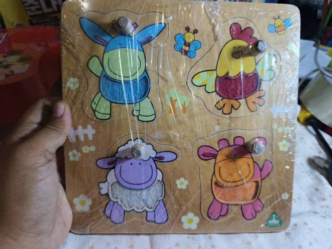 ELC Wooden Peg Puzzles Transport and Animals Bundle (Category: Educational & Learning Toys) located in Caloocan City. Submitted by mckysprelove (Listing ID 1467879010, Image 2). Description: - Pre loved ELC Wooden Puzzle -Set of 2 wooden peg puzzles from Early Learning Centre - Board 1 features vehicles: fire truck, ambulance, and double-decker bus - Board 2 features farm animals: sheep, donkey, and rooster - Designed with easy-to-grab wooden kno