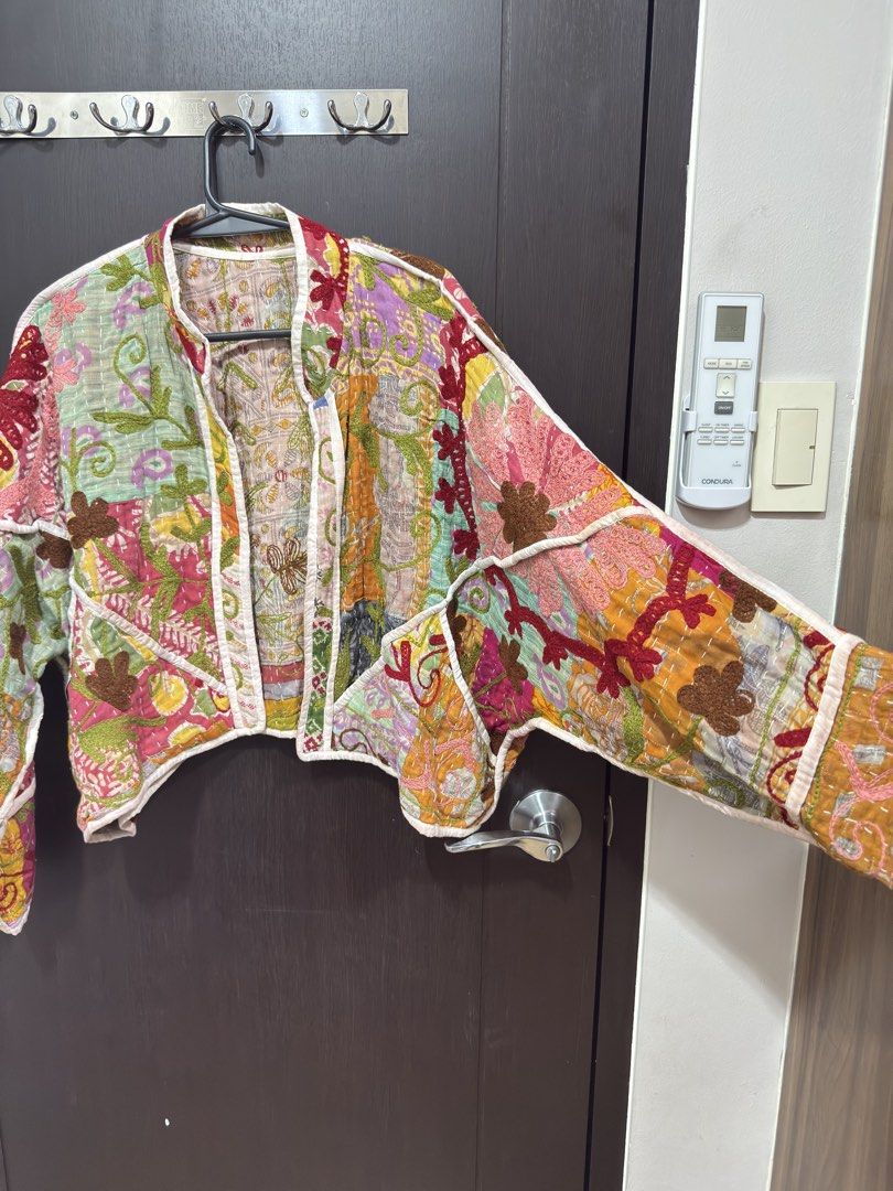 Elinora kantha jacket (Category: Coats, Jackets and Outerwear) located in Muntinlupa City. Submitted by g0ldfishh (Listing ID 1467706941, Image 1). Description: SRP 6500 - Style: Open front quilted kantha jacket with a short, boxy cut and long sleeves - Material: Lightweight cotton with traditional kantha stitching - Design: Vibrant patchwork featuring pink, green, yellow, and purple fabrics - Details: Finished with crisp white piped trim - Condi