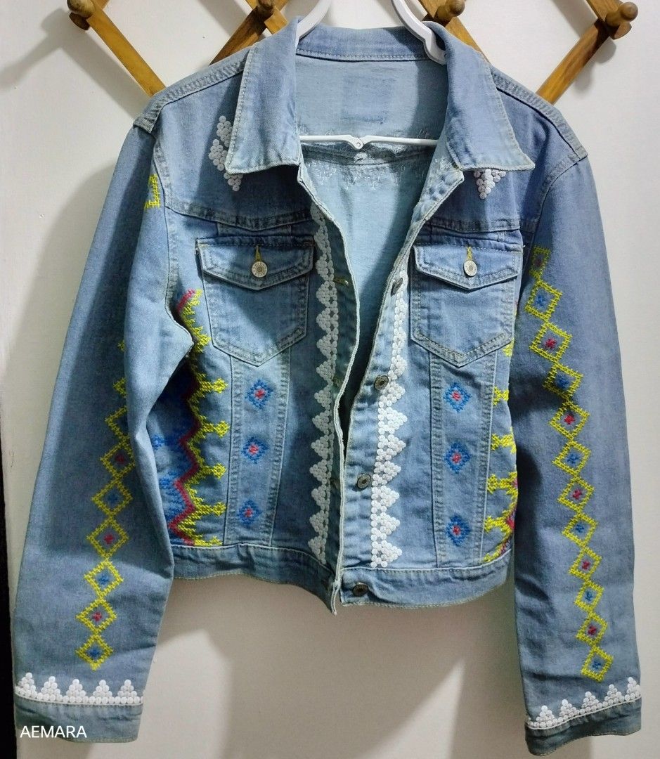 Embroidered Denim Jacket (Category: Coats, Jackets and Outerwear) located in Caloocan City. Submitted by almaeternamara (Listing ID 1468044281, Image 1). Description: - Size: Shoulder 18; Arm Length 24 - Color: Light Blue - Design: Intricate multicolored geometric embroidery with white beaded accents on the front, back yoke, and sleeves - Condition: Well-maintained and stylish - Perfect for casual outings and daily OOTDs Needs cleaning/wash sf by