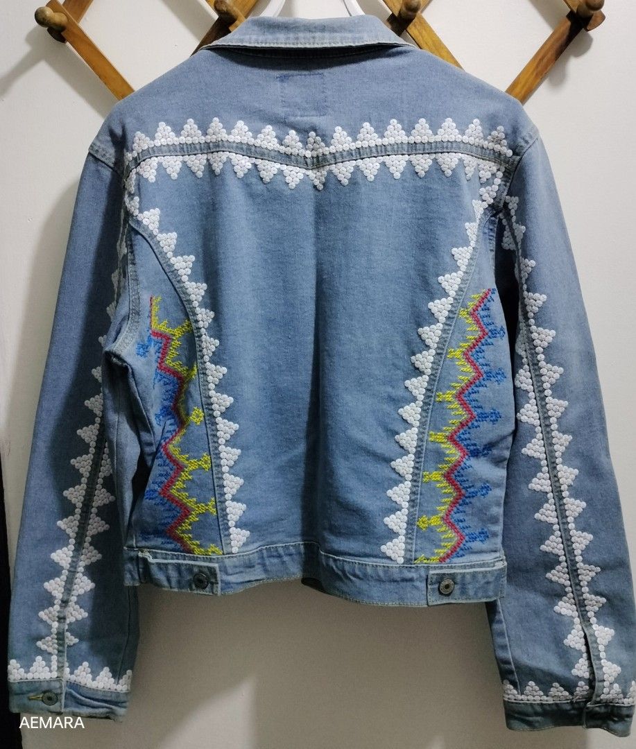 Embroidered Denim Jacket (Category: Coats, Jackets and Outerwear) located in Caloocan City. Submitted by almaeternamara (Listing ID 1468044281, Image 2). Description: - Size: Shoulder 18; Arm Length 24 - Color: Light Blue - Design: Intricate multicolored geometric embroidery with white beaded accents on the front, back yoke, and sleeves - Condition: Well-maintained and stylish - Perfect for casual outings and daily OOTDs Needs cleaning/wash sf by