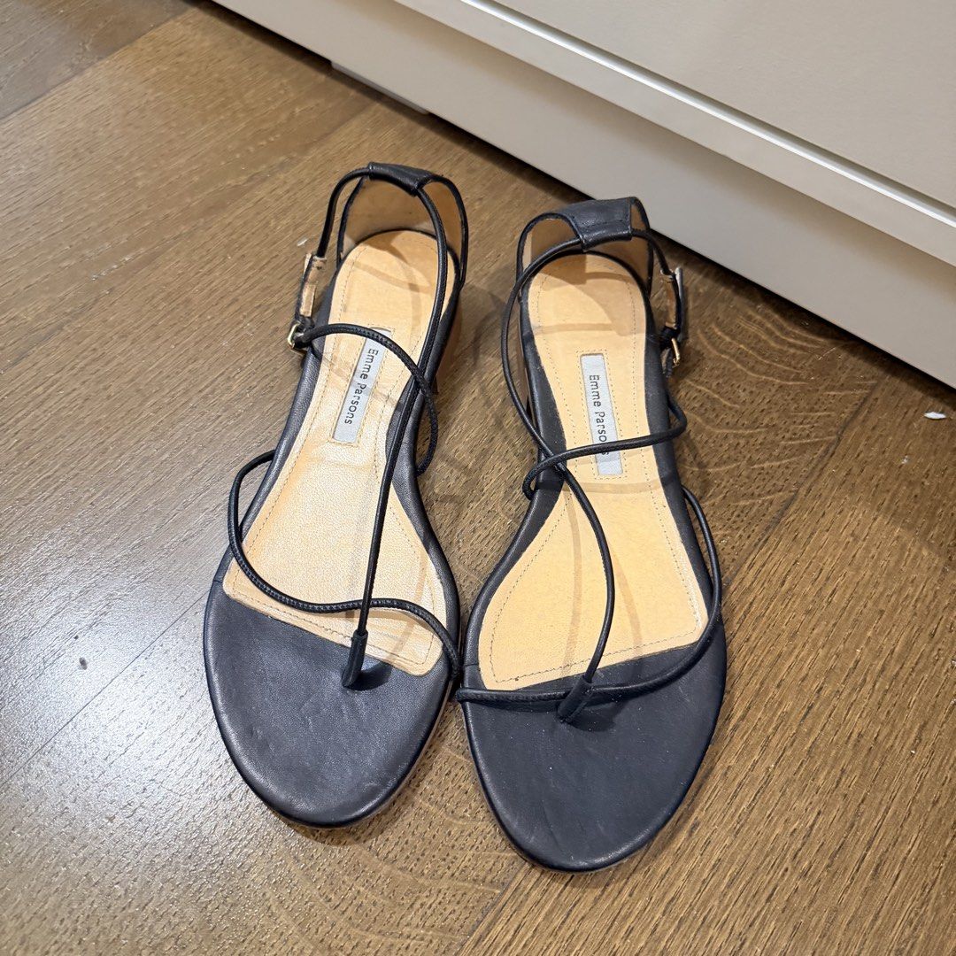 Emme Parsons String Leather Sandals in Black (Category: Flats & Sandals) located in Makati City. Submitted by agl.ph (Listing ID 1467890092, Image 3). Description: - Brand/Model: Emme Parsons Black Leather Sandals - Size: EU 38 - Purchased for $395 - Design: Minimalist strappy style featuring a toe ring and adjustable buckle ankle closure - Material: Premium leather upper and footbed with a flat wooden sole - Condition: Very used condition, with 