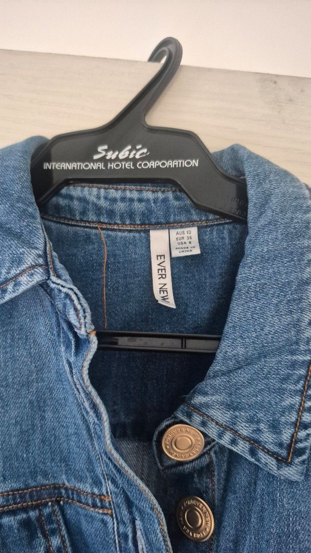Ever New Denim Jacket Blue Size AUS 10 (Category: Coats, Jackets and Outerwear) located in Taguig. Submitted by declutter_it420 (Listing ID 1467888270, Image 1). Description: - Brand: Ever New - Color: Classic Blue Denim Dress - Size: AUS 10 / EUR 38 / US 6 - Details: Metal buttons with embossed brand text, classic collar, and contrast stitching - Condition: Great wardrobe staple, perfect for cooler days.