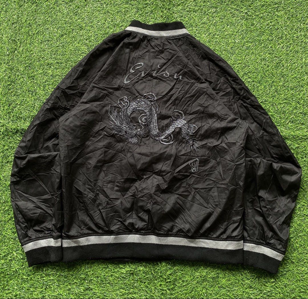 Evisu Black Dragon Bomber Jacket Size XL (Category: Coats, Jackets and Outerwear) located in Manila. Submitted by clevermountain_9c1516 (Listing ID 1467910932, Image 2). Description: - Brand: Evisu - Style: Black bomber jacket with full zip front - Size: 105 XL - Material: 100% polyester - Design: Detailed black twin dragon embroidery on the chest, large dragon graphic on the back, and Evisu cursive script lettering - Features: Zippered front poc