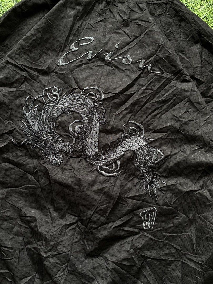 Evisu Black Dragon Bomber Jacket Size XL (Category: Coats, Jackets and Outerwear) located in Manila. Submitted by clevermountain_9c1516 (Listing ID 1467910932, Image 3). Description: - Brand: Evisu - Style: Black bomber jacket with full zip front - Size: 105 XL - Material: 100% polyester - Design: Detailed black twin dragon embroidery on the chest, large dragon graphic on the back, and Evisu cursive script lettering - Features: Zippered front poc