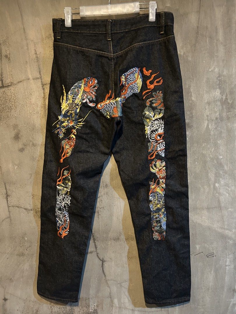 Evisu embroidered dragon design (Category: Jeans) located in Manila. Submitted by jayson221 (Listing ID 1467996733, Image 1). Description: Dimes W:31 L:39 Excellent condition No issue 10/10 colo rate - Style: Straight fit dark wash denim jeans - Design: Heavy, vibrant embroidery with dragon and flame motifs - Colors: Blue, orange, white, and yellow threads on solid indigo - Details: Standard waistband and belt loops - Condition: Unique statement 